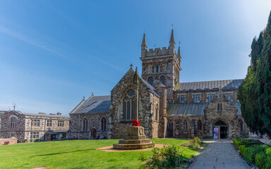 Wimborne Minster, UK - April 27th 2025: The grade II listed War Memorial in front of the grade I listed Minster Church of St Cuthberga.