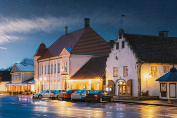 Kuressaare, Estonia. Old Gross Weight Storage Building House Near Market In Tallinna Street At Evening Night. Street In Fesive Christmas Xmas New Year Illuminations.