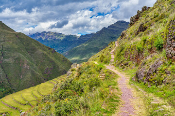 Fototapeta premium A hiking trail offering panoramic view with the Sacred Valley from the Pisac archaeological site in the Peruvian Andes.