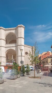 Panorama showing church of San Benito el Real timelapse, a historic Benedictine monastery in Valladolid, Spain. The Gothic-style facade stands tall under a blue sky, essence of medieval architecture.