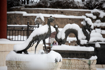 Dragon and Phoenix sculptures in snow at the Summer Palace, Beijing, China