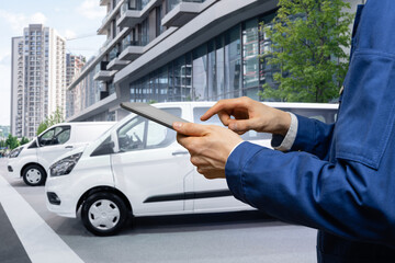 Manager with a digital tablet on the background of van. Fleet management