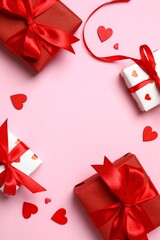 Festive frame with gift boxes with red hearts on pink background. St.Valentine's Day