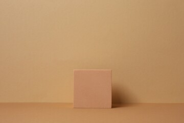 Beige podium features a smooth, textured surface under soft tones. Ideal for product mockups, cosmetic displays, or minimal brand presentations. 3D rendering