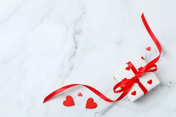 Festive gift box with red hearts on marble background. St.Valentine's Day