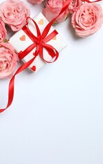 Beautiful composition with pink roses and gift box on white background. Ideal for Valentine's Day, March 8th, Birthday or other holidays