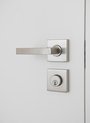 Modern brushed nickel door handle and door lock on a white door. Home security and interior design element for residential space.