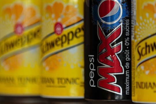 Kortenaken, Belgium - October 4, 2014: Close-up shot of Pepsi Max can and Schweppes Indian Tonic cans on retail shelf, highlighting zero sugar beverage options and commercial brand packaging