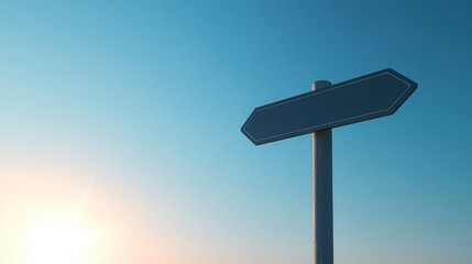 A blank directional sign stands against a clear blue sky, symbolizing choice and direction during a serene sunset.