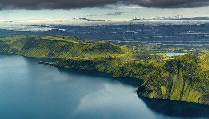 aerial view of the idyllic Langisjor Lake in the Highlands of Iceland with its dark blue waters and green moss-covered volcanic mountains © makasana photo