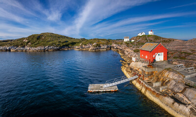 Fototapeta premium view of the historic Stavneset Lighthouse on the entrance of the Bremsnesfjorden Fjord near Kristiansund