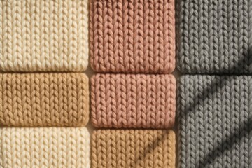 Arranging knitted wool fabric swatches in a grid pattern. Displaying soft textile texture and different color palettes