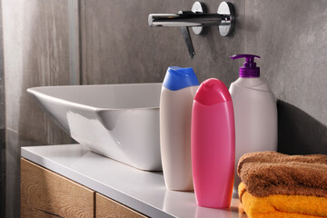 Plastic bottles of body care and beauty products in the bathroom