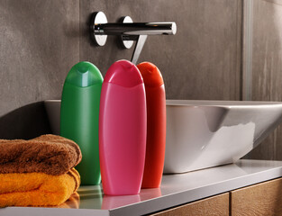 Plastic bottles of body care and beauty products in the bathroom