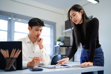 Happy busy female mentor executive manager training young male employee at work. Two diverse professional business team people working on financial management in office using digital tablet