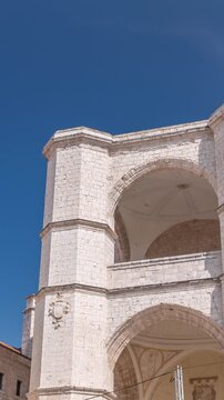 Church of San Benito el Real timelapse, a historic Benedictine monastery in Valladolid, Spain. The Gothic-style facade stands tall under a blue sky, capturing the essence of medieval architecture.