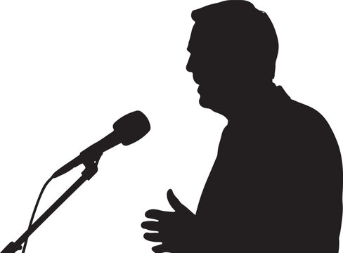 Silhouette of a man gesturing with hands near a microphone