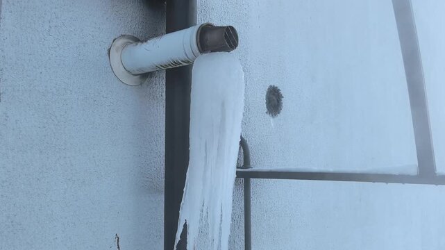A repair process is underway to fix a heating system after pipes froze due to cold temperatures. The work is essential to restore warmth in the building's apartments.
