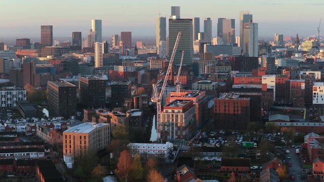 Aerial video from Miles Platting across Ancoats, featuring One Port Street  and the dense skyscraper clusters of the Manchester city centre during a winter sunrise.