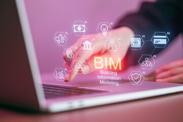 Using digital tools for building information modeling in a workspace with a laptop and icons representing technology and design