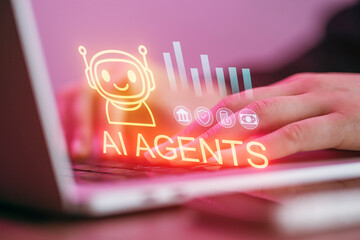 Users interact with a laptop showing AI agents and data graphics in a tech workspace