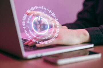 Engagement with digital tools while working on a laptop at a workspace in the evening