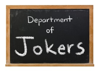 Obraz premium Department of jokers handwritten in white chalk on a black chalkboard in a wooden frame isolated on white.
