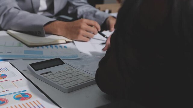 Asian male financial officer or accountant checking investment results Financial budget analysis Planning to summarize results and report to the meeting Audit concept and investment results.