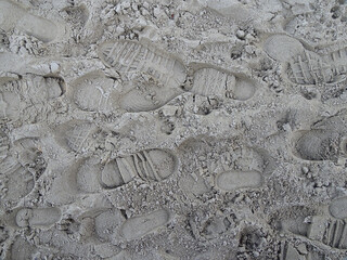 Several footprints on a beach