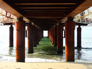 Rustic Pier Symmetry Over Calm Ocean Waters