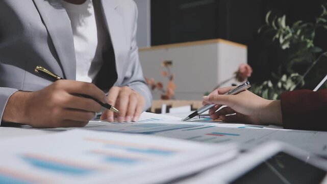 Asian male financial officer or accountant checking investment results Financial budget analysis Planning to summarize results and report to the meeting Audit concept and investment results.