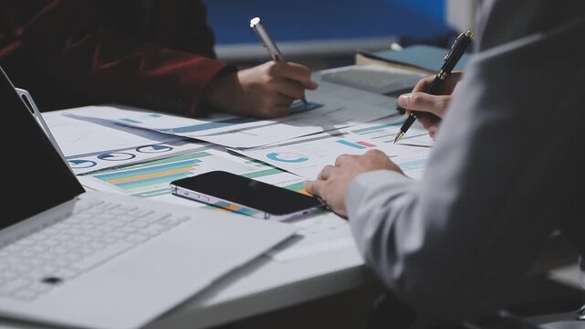Asian male financial officer or accountant checking investment results Financial budget analysis Planning to summarize results and report to the meeting Audit concept and investment results.
