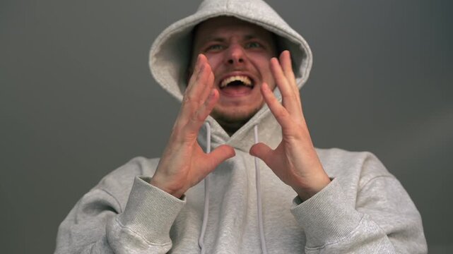 A cunning man in a hood rubs his hands.
A vindictive man rubs his palms and waits for revenge.
Revenge and a cunning plan