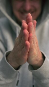 A man with a cunning plan rubs his palms.
A gesture of a vengeful man.
The emergence of a plan and a cunning plot.