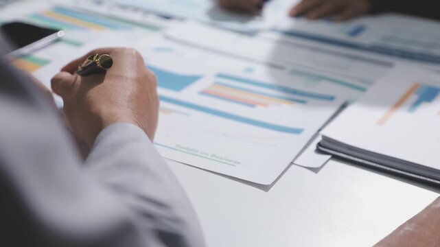 Asian male financial officer or accountant checking investment results Financial budget analysis Planning to summarize results and report to the meeting Audit concept and investment results.