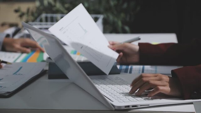 Asian male financial officer or accountant checking investment results Financial budget analysis Planning to summarize results and report to the meeting Audit concept and investment results.