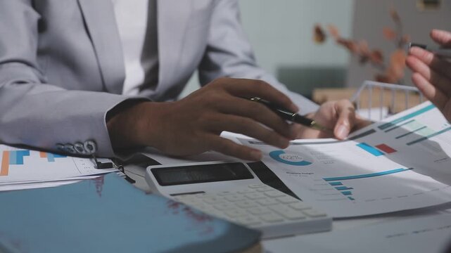 Asian male financial officer or accountant checking investment results Financial budget analysis Planning to summarize results and report to the meeting Audit concept and investment results.