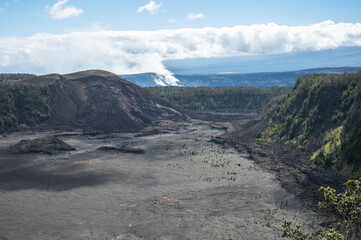 Volcanic crater with solidified lava lake and surrounding rainforest viewed from overlook on Big Island Hawaii © EyesTravelling