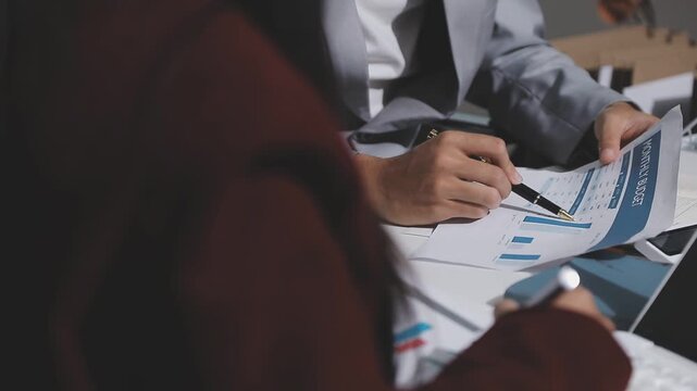 Asian male financial officer or accountant checking investment results Financial budget analysis Planning to summarize results and report to the meeting Audit concept and investment results.