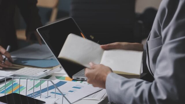 Asian male financial officer or accountant checking investment results Financial budget analysis Planning to summarize results and report to the meeting Audit concept and investment results.