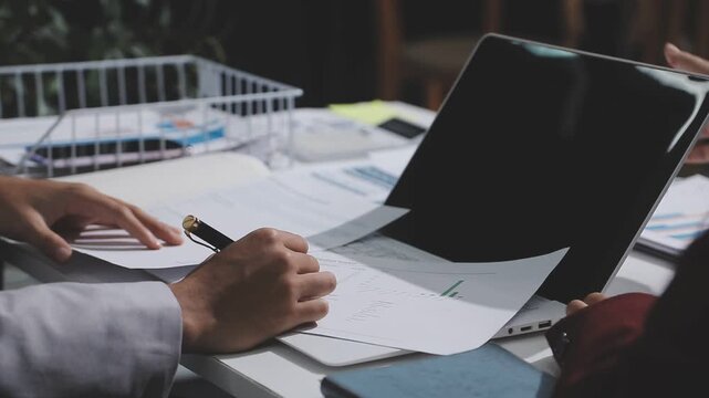 Asian male financial officer or accountant checking investment results Financial budget analysis Planning to summarize results and report to the meeting Audit concept and investment results.