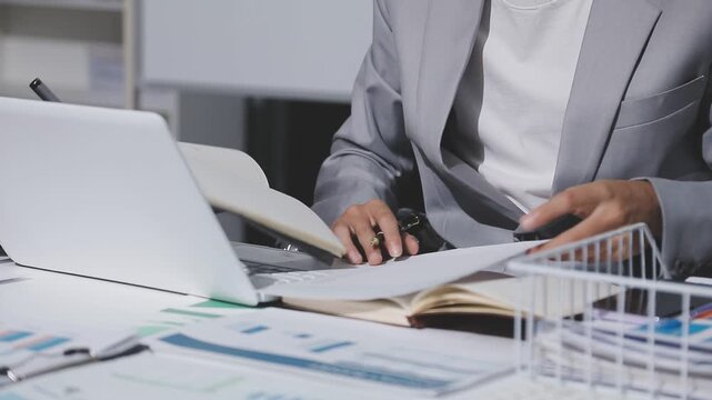 Asian male financial officer or accountant checking investment results Financial budget analysis Planning to summarize results and report to the meeting Audit concept and investment results.