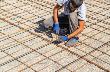Knitting metal reinforcement for a swimming pool. Selective focus.
