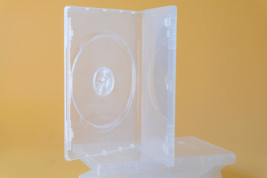Blank CD case or CD cover on color background.
