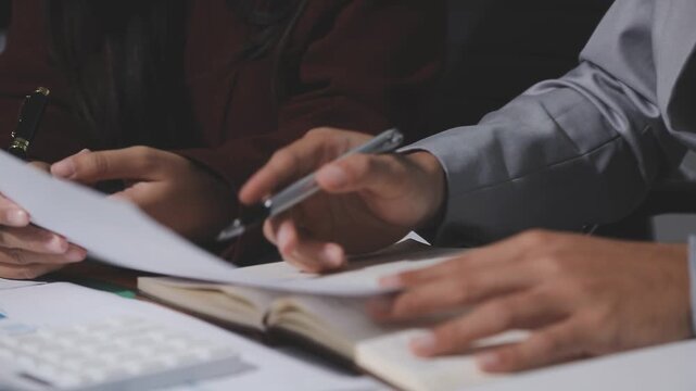 Asian male financial officer or accountant checking investment results Financial budget analysis Planning to summarize results and report to the meeting Audit concept and investment results.