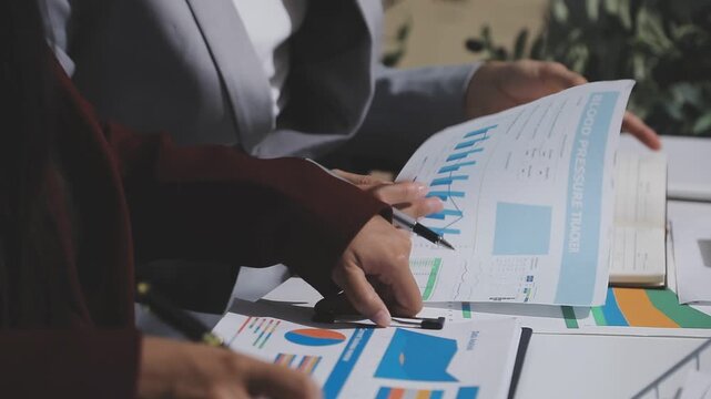 Asian male financial officer or accountant checking investment results Financial budget analysis Planning to summarize results and report to the meeting Audit concept and investment results.