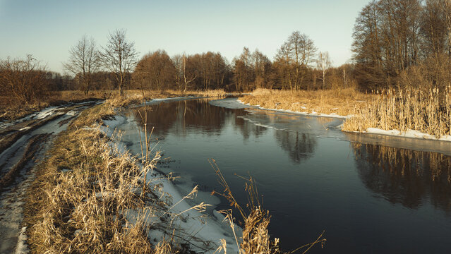 Winter and snow on the small Grabia River, Poland.
