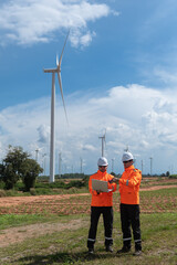 Engineers working on site in wind turbine farm, Wind turbines generate clean energy source, Eco...