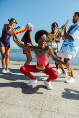 Carnival dancers celebrate by the sea