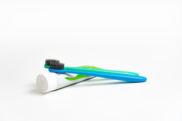A two toothbrush with toothpaste on white background with copy space, close-up. Dental oral hygiene concept